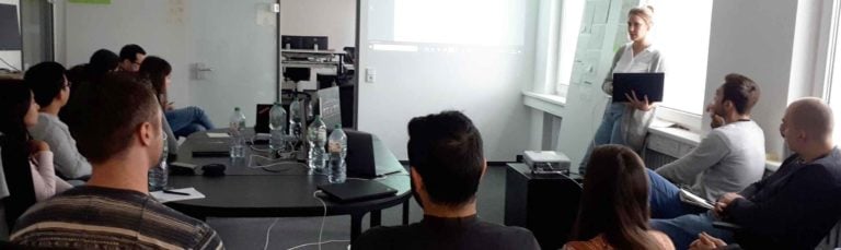 A group of employees paying attention at a presentation held by a student who interned at Saloodo!.