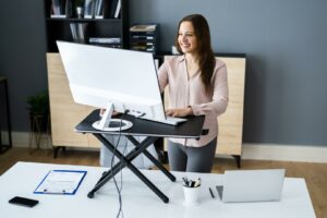 Woman standing at her desk working