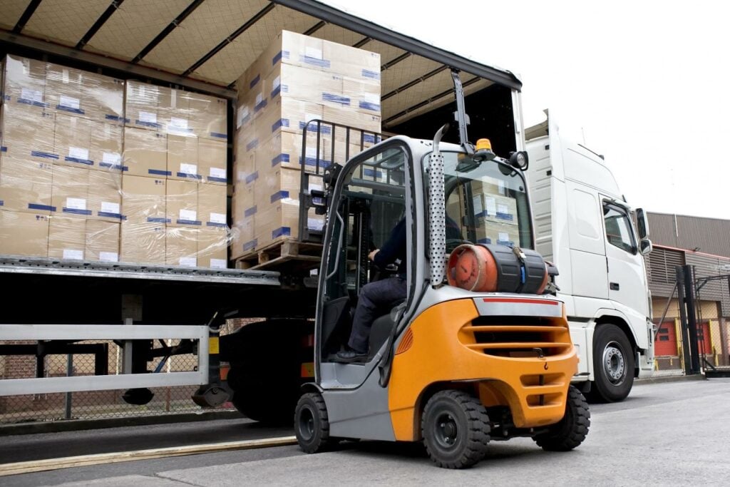 Picture of a forklift unloading a truck