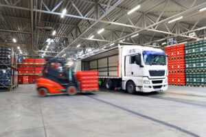 Loading lorries in logistics hall // shipping