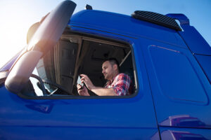 Truck driver using a tablet as symbol pic for paperless logistics