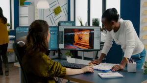 Two women working in gaming industry looking at a screen