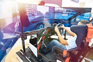 Man sitting in a virtual reality car simulator