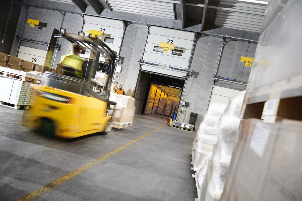 Forklift loading cargo into DHL Freight truck in Denmark