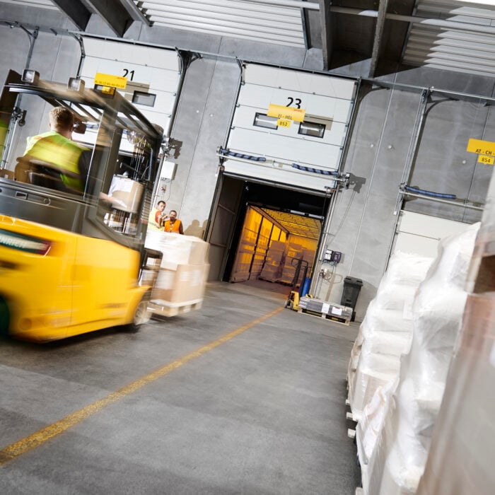 Forklift loading cargo into DHL Freight truck in Denmark